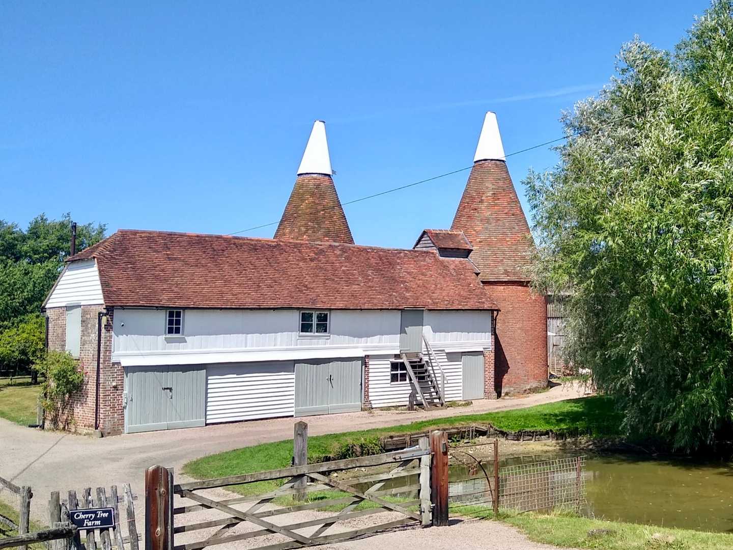 Kentish oast house with white cowls at a farm in Frittenden — rural Kent homes like this often need a survey before a move abroad